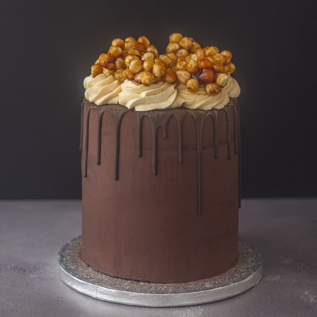 Delicious chocolate cake topped with hazelnuts and coffee cream