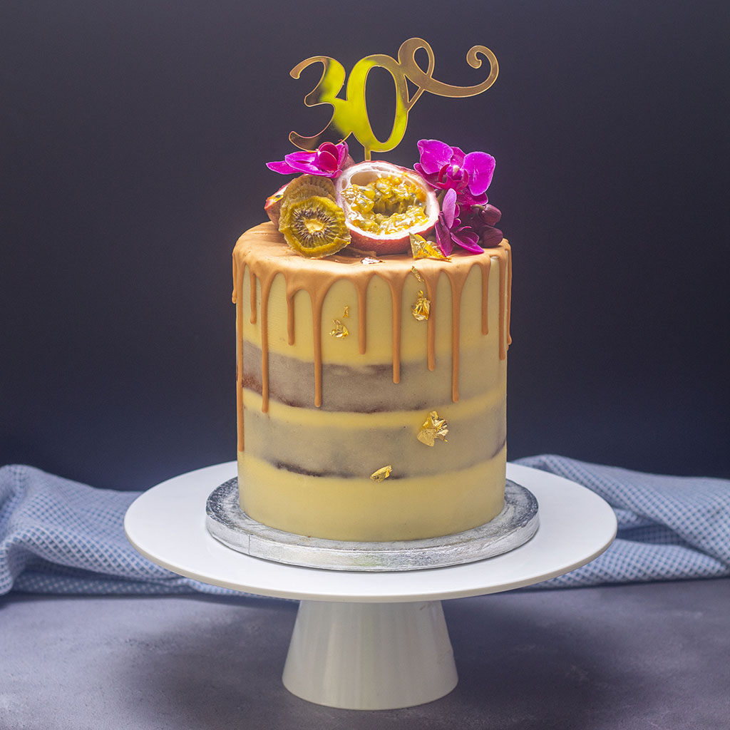 Toffee and passion fruit birthday cake decorated with gold leaf